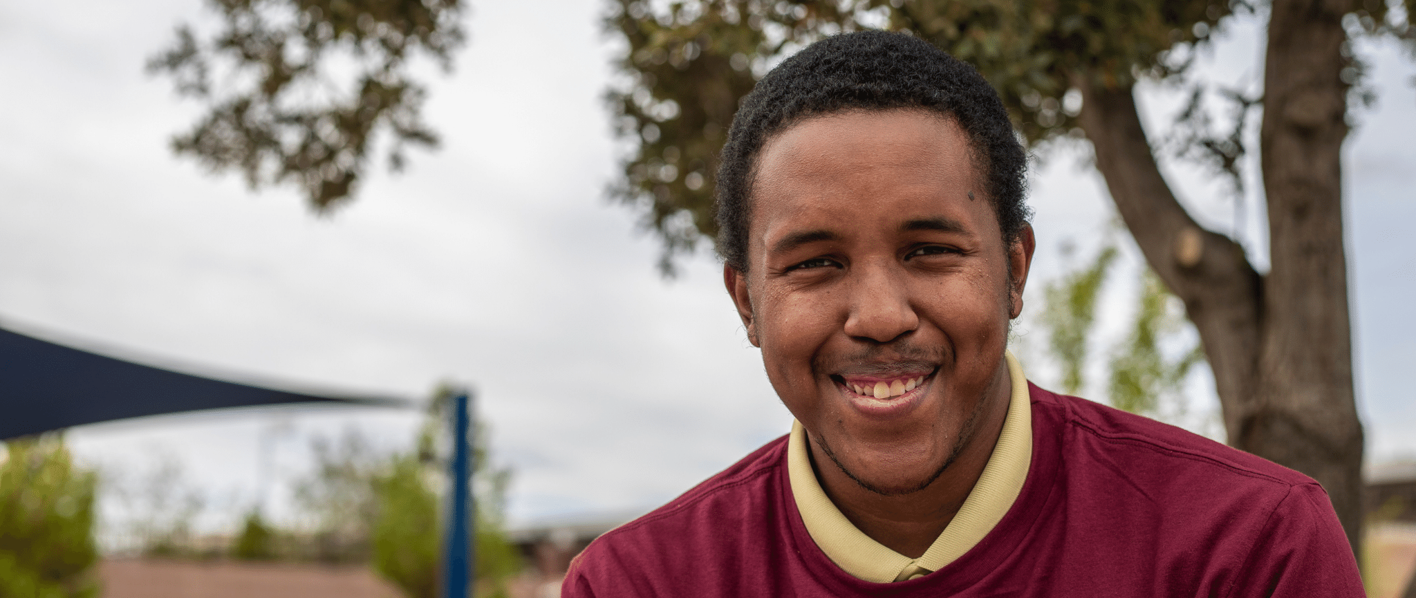 Young black person living with a developmental disability smiling